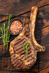 Grilled Tomahawk beef steak, cooked rib eye with bone. wooden background. top view