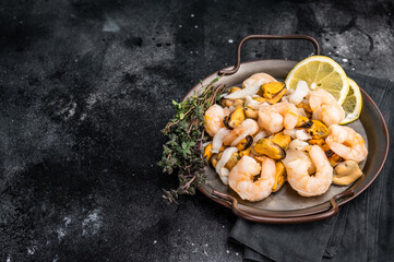 Fresh Seafood Mix with Mussels, Clams, Prawns, Shrimps and squid. black background. top view