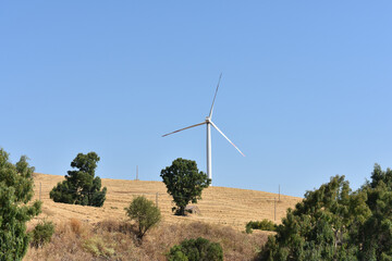 Wind turbine on the mountain in Sicily, Italy. Wind turbine and countryside Italian summer...