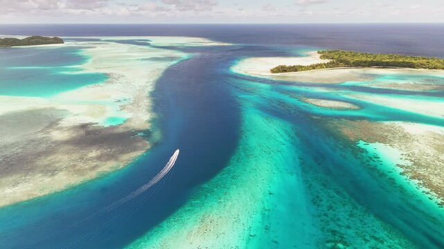 High-quality drone shot sweeping across the vibrant blue ocean and scenic islands in Palau. Wide aerial shot.