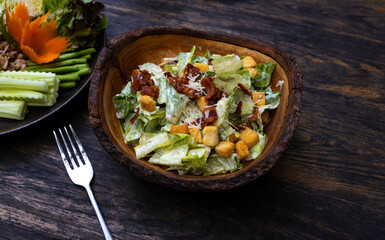 Fresh caesar salad with croutons and parmasan cheese in bowl