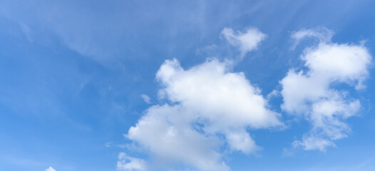 Low angle view and full frame of beautiful blue sky with strange shape of fluffy white clouds in the afternoon on sunny day used as natural background texture in decorative art work