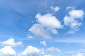 Low angle view and full frame of beautiful blue sky with strange shape of fluffy white clouds in the afternoon on sunny day used as natural background texture in decorative art work