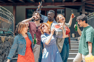 Friends enjoying house party with beer and music player