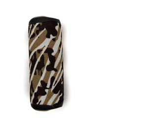 A speaker with a camouflage design is sitting on a white background. The speaker is black and white, and it has a brown and white pattern