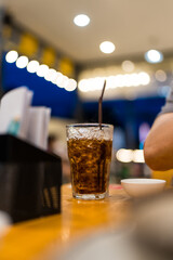 A soft drink in a glass on the table. Refreshing dark soda © Dontree