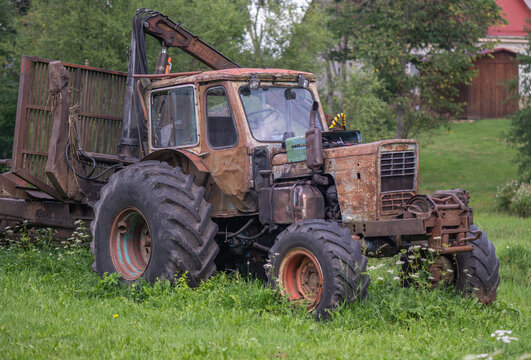 A rusty old farm tractor . - Powered by Adobe