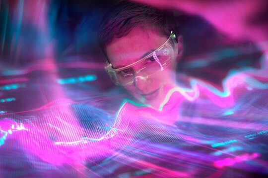 Woman engineer with AR glasses interacting with data stream