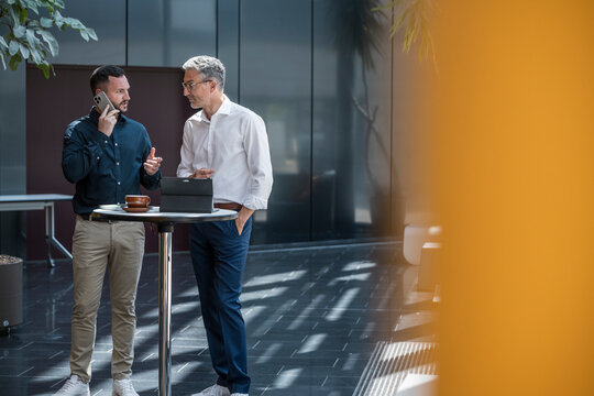 Business managers discussing project at modern office table