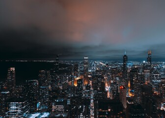 Obraz premium Chicago skyline at night with dramatic sky.