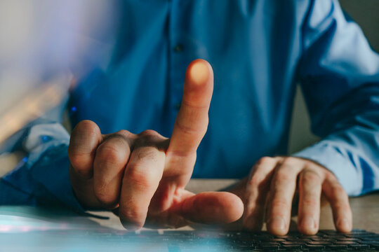 Close up of hand scanning fingerprint for security on laptop