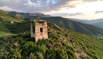 Old Stone Tower Sits Atop Green Hill with Mountain View