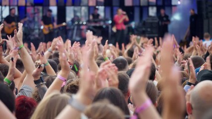 A Vibrant and Energetic Crowd Engaged in the Thrilling Live Music Festival Experience and Atmosphere