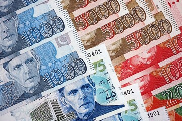 Pakistan rupees banknotes close up. The current Pakistan money bills lies on table in big amount