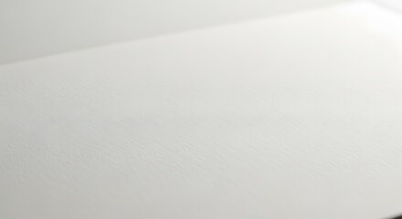 Obraz premium Close-up of Textured White Paper with Diagonal Shadow Abstract Minimalist Background