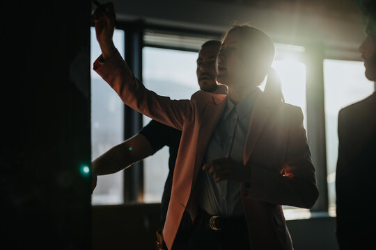 A team of colleagues engaging in discussions and brainstorming during a sunny day in a modern workspace. The scene captures collaboration, teamwork, and professional interactions in the workplace.