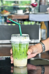 hand holding a glass of juice