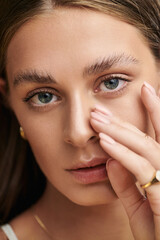 Summer beauty: Young woman with natural makeup in a serene studio setting
