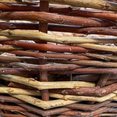 Closeup of traditional hand-woven wicker basket made from natural vine twigs, rustic texture for craft, background, or eco design use