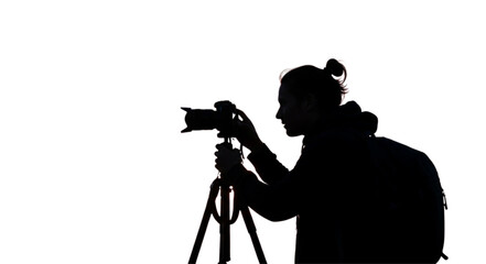 Silhouette of a professional photographer with a camera and tripod