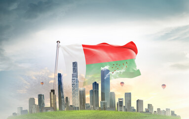 Madagascar  national flag wavering with modern building skyline. Country showing stronger and prosperity. Flag key visual. Madagascar national flag for independence day.