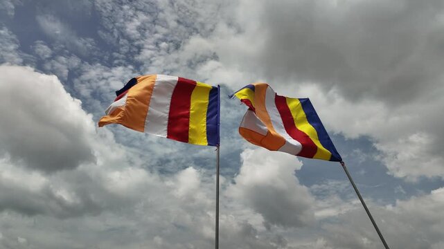 Timelapse Video of Two Colourful Buddhist Flags Waving in the Wind Against Cloudy Sky in Lien Hoa Pagoda, My Tho, Dong That, Vietnam: 