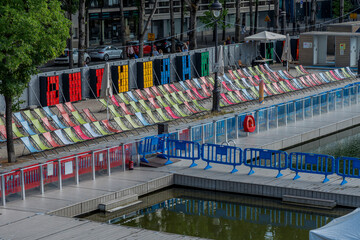 Paris, France - 07 19 2025: Paris Beach, Bassin de la Villette. Detail view of the oudoor swiming pool and the instalations along the quays during Paris Beach in summer