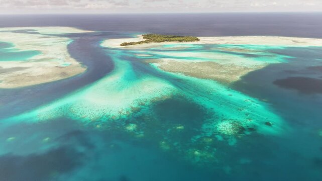 Breathtaking drone view orbiting to expose the surreal ocean hues and remote sandy islands surrounding Palau. Orbiting wide drone shot.