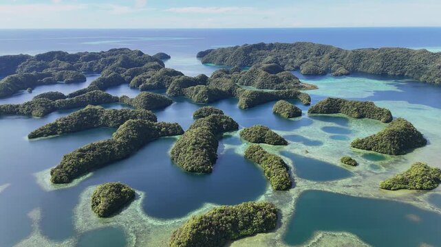 High-quality drone shot revealing the surreal ocean hues and remote islands around Palau. Wide revealing drone shot.