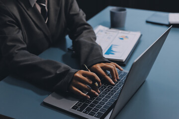 Close up of business woman hands typing on laptop computer and digital tablet, searching and...