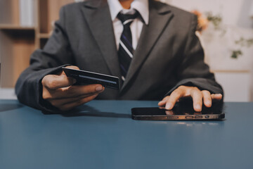 Online payment,businessman hands holding credit card and using  laptop for online shopping. Cyber...