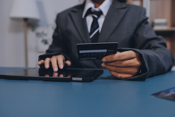 Online payment,businessman hands holding credit card and using  laptop for online shopping. Cyber...