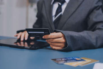 Online payment,businessman hands holding credit card and using  laptop for online shopping. Cyber Monday Concept