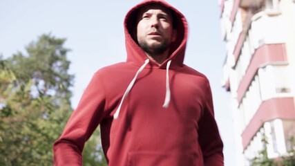 Athletic man running within the city. Concept of willpower and motivation, achieving goals.