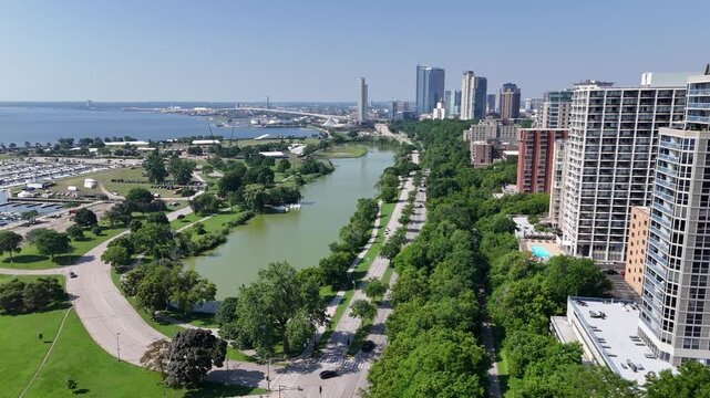 Aerial view of North Lincoln Memorial Drive in Milwaukee WI featuring the MKE skyline, McKinnley Marina and lagoon and Veterans Memorial Park