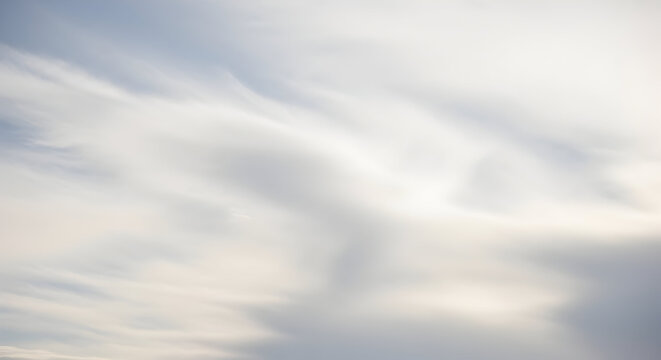 Abstract blurred image of soft white and gray clouds creating a dreamy and ethereal atmosphere view
