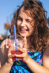 Happy Child Girl Drinking Lemonade On The Beach