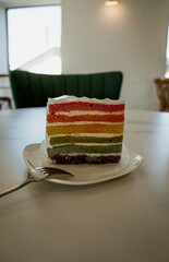 Fresh baked homemade Rainbow cake set on table.