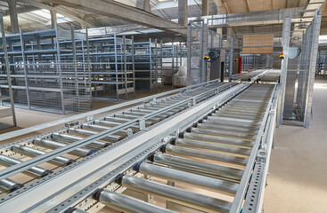 Automated Roller Conveyor in Warehouse Aisle