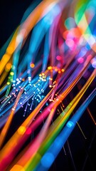 Obraz premium Abstract image of vibrant, colorful fiber optic cables with glowing ends against a dark background.