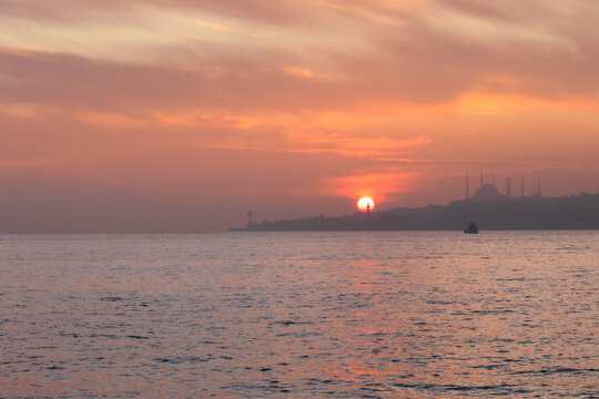 Silhouette of blue mosque and Hagia Sofia, on the background of the sea at sunset and historic peninsula