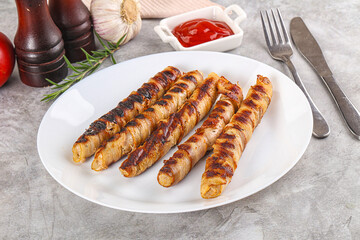 Grilled meat sausages wrapped bacon