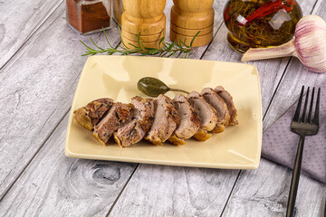 Roasted duck breast slices in the plate
