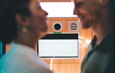 Smiling couple mid-laugh near kiosk captures emotional tech interaction, shared digital amusement,...