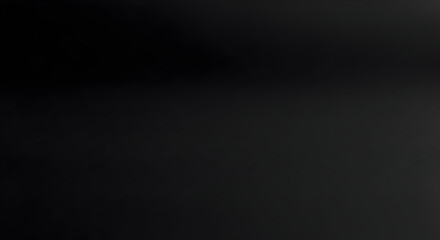 A completely dark image showing a gradient of black to dark grey with no discernible objects present