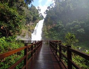 Tropical wooden pier stretching over turquoise waters toward a paradise island under a clear sky
