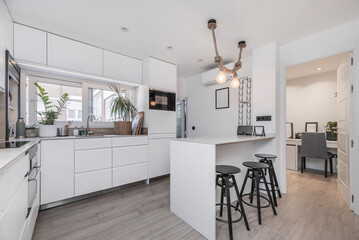 To maintain a clean aesthetic, many appliances can be paneled behind conventional cabinetry