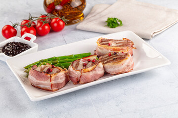 Tasty grilled pork medallion with bacon