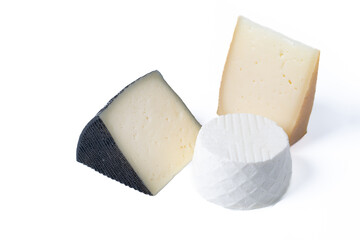 Different cheeses with nuts, figs and grapes isolated on white background