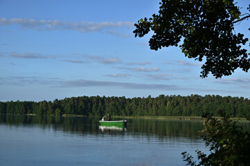 boat with fishermen on the lake on a summer morning